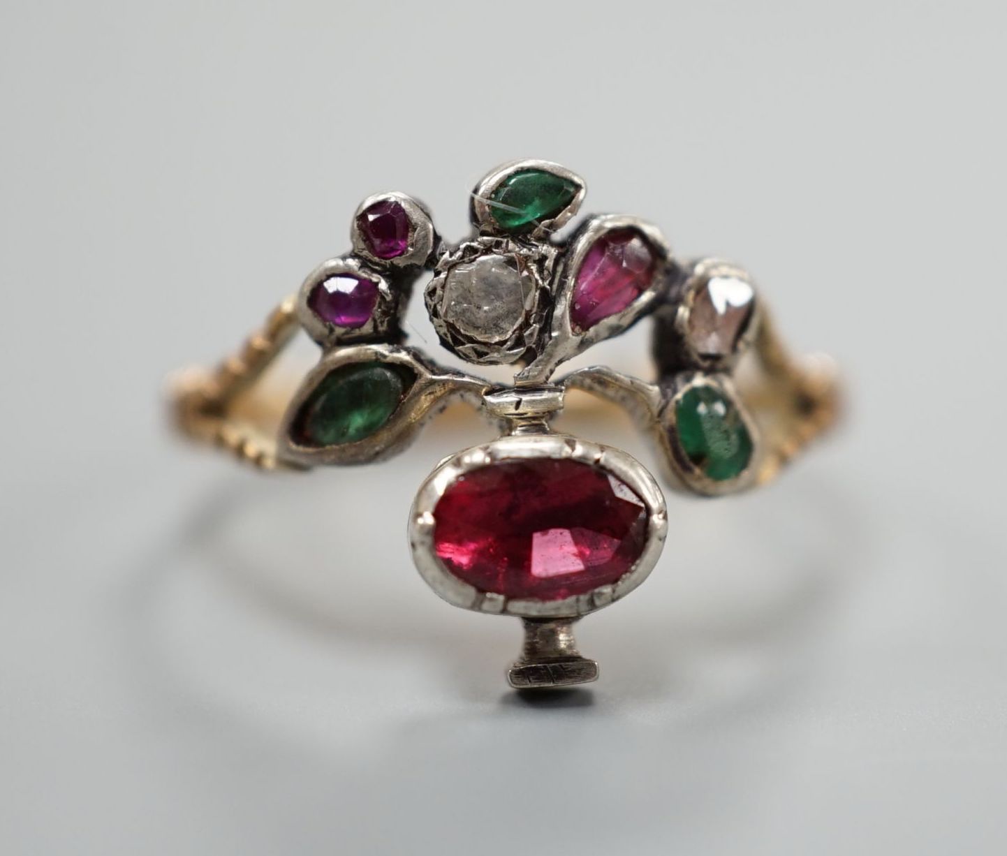 An early 20th century continental? Arts & Crafts yellow metal and multi gem set cluster ring, size P, gross weight 2.4 grams.